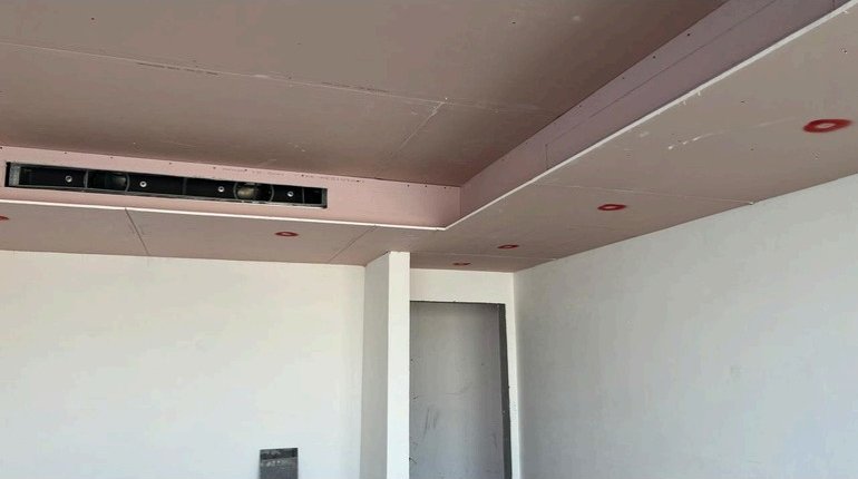 Gypsum bulkhead ceiling with integrated speaker slots