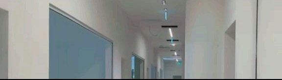 Finished corridor with glazed partitions and lighting